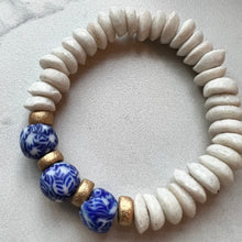Load image into Gallery viewer, For the lover of blue and white coastal colors, this bracelet features white Ashanti beads and blue and white recycled glass beads with gold wood accents