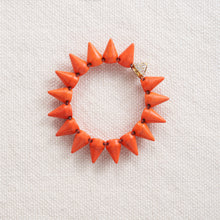 Load image into Gallery viewer, A smaller version of the original spike bracelet, Howlite is said to calm communication, facilitate awareness and encourage emotional expression. In spike form, these make for a great edgy addition to any outfit. Each bracelet has one rhinestone studded accent spike to add a little bling and edge to your arm party. Available in black, white, orange, and purple