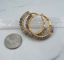Load image into Gallery viewer, 1.5 inch 24kt gold filled hoops are hand wrapped with gorgeous faceted gemstones. These handcrafted earrings provide just the right amount of sparkle to make any outfit shine The earrings include AAA quality gemstones, they are natural, undyed, superbly faceted and vibrant