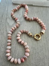Load image into Gallery viewer, Embrace the allure of the "Pretty in Pink" Necklace. Hand-knotted on pink silk thread, this 18-inch beauty features natural faceted pink Peruvian opals, exuding captivating charm and femininity. The gold-filled end caps and sailor's clasp offer easy wearability and the opportunity to add or remove a charm of your choice. Discover elegance and refine your style with this exquisite necklace. Shop now to experience the beauty of pink opals.