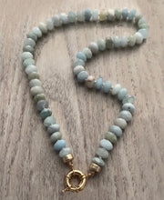 Load image into Gallery viewer, Discover the allure of the "Aquamarine Bliss" Necklace. Hand-knotted on silk thread, this 19-inch necklace features stunning 9mm faceted AAA quality aquamarines, radiating brilliance and elegance. The gold-filled sailor clasp allows for easy on and off and offers the perfect opportunity to add your favorite pendant. Elevate your style and attract attention with this exquisite piece. Shop now to experience the bliss of aquamarines.