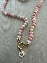 Load image into Gallery viewer, Embrace the allure of the "Pretty in Pink" Necklace. Hand-knotted on pink silk thread, this 18-inch beauty features natural faceted pink Peruvian opals, exuding captivating charm and femininity. The gold-filled end caps and sailor's clasp offer easy wearability and the opportunity to add or remove a charm of your choice. Discover elegance and refine your style with this exquisite necklace. Shop now to experience the beauty of pink opals.