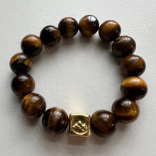 Load image into Gallery viewer, Welcome to the Elemental Elegance collection! Nature-inspired jewelry, where gemstones meet the timeless wisdom of the elements. Earth – solid and steadfast. Black Tourmaline and tiger eye connect you to the earth&#39;s energy, reminding you to stay rooted in the present moment while nurturing your dreams from the ground up  Each tiger eye  bracelet is made with real quality gemstones and a gold filled element bead
