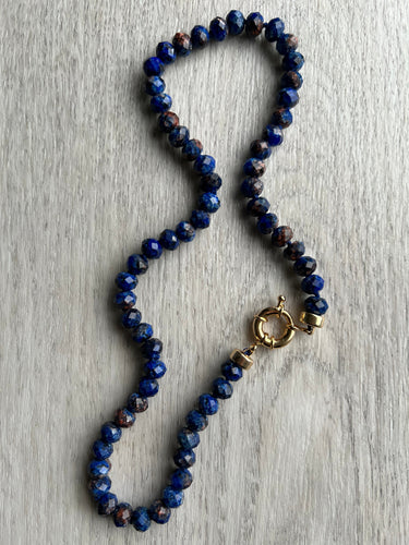 With stunning faceted 8mm Lapis Lazuli gemstones hand knotted on blue silk, this 18 inch necklace is the most gorgeous of blues.    The necklace is completed with 14kt gold filled end caps and sailor clasp that allows for easy on and off and to add and remove your favorite charm 