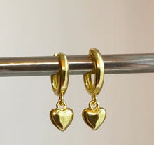 Load image into Gallery viewer, Small gold filled hoop earrings adorned with small gold heart charm are the perfect accessory to wear as a set or in a second or third piercing 
