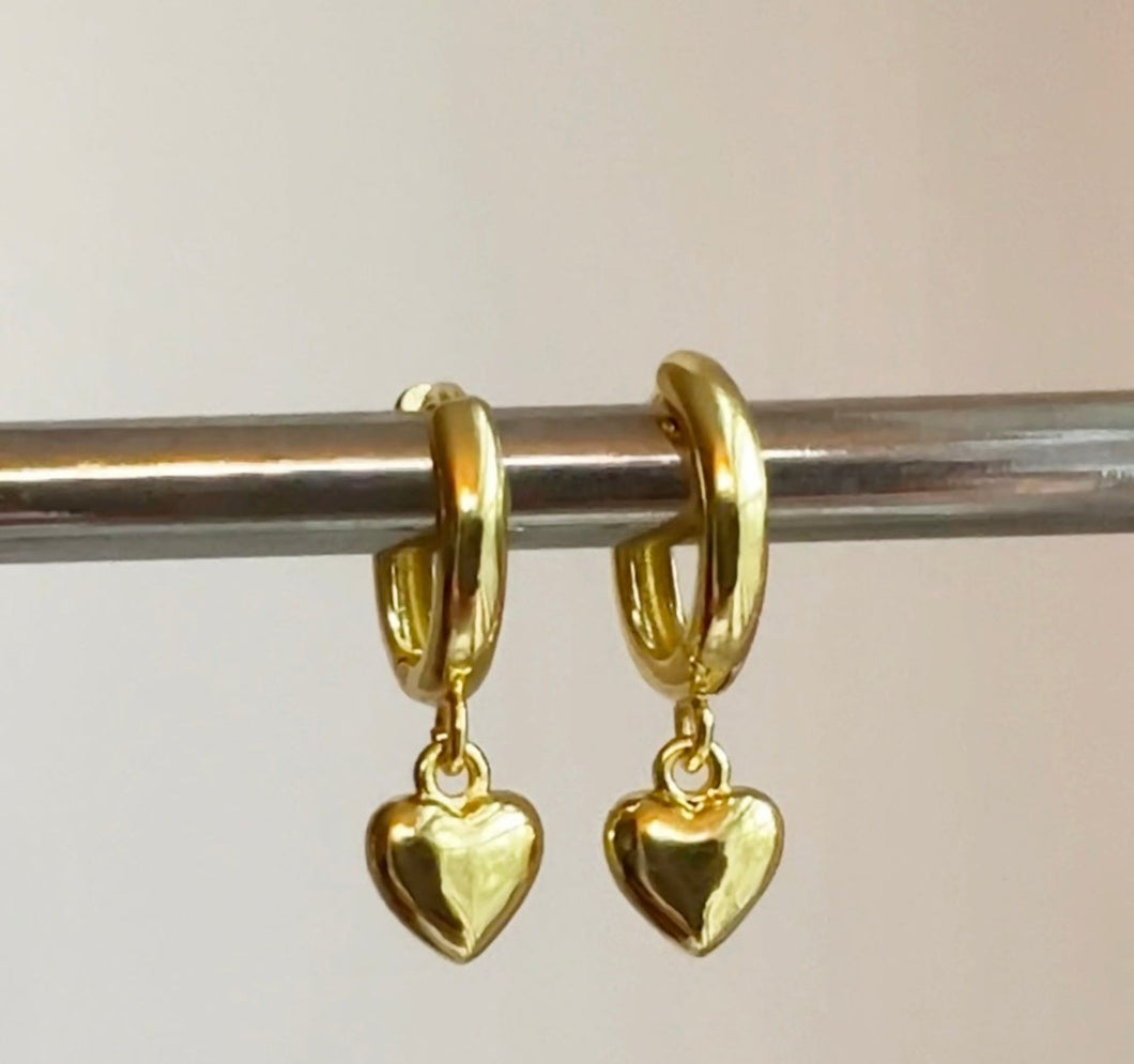 Small gold filled hoop earrings adorned with small gold heart charm are the perfect accessory to wear as a set or in a second or third piercing 