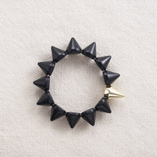 Load image into Gallery viewer, A calming stone, Howlite calms communication, facilitates awareness and encourages emotional expression.  In spike form, these make for a great edgy addition to any outfit.   Each bracelet has one accent gold spike  Available in black, white, red, pink, yellow, orange, turquoise, blue and purple
