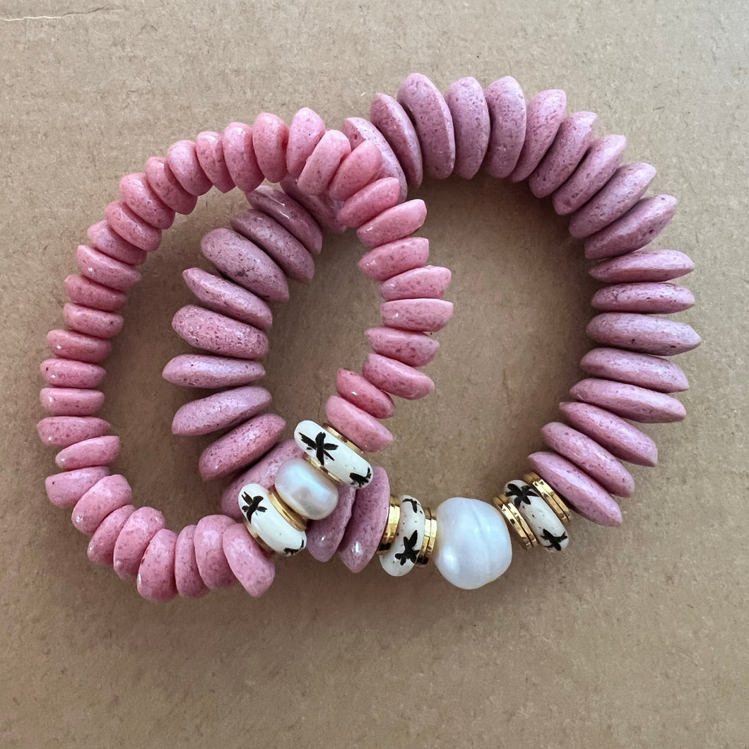 Matching bracelets with pink ashanti beads, a single fresh water pearl and carved star bone beads Mommy bracelet measures seven inches but can be customized upon request.  Mini bracelet will be customized. Please mention child’s age in the notes (default will be six inches)