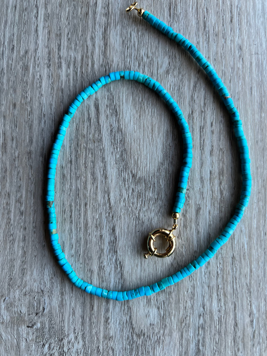 A perfect layering piece, this turquoise heishi necklace measures 19 inches   Finished off with gold filled end caps and a gold filled sailor's clasp