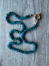Load image into Gallery viewer, Hand knotted on blue silk, these pretty blue apatite heishi beads come together to create a stunning 19 inch necklace that&#39;s perfect on it&#39;s own or in your favorite necklace stack Finished off with gold filled end caps and a gold filled sailor&#39;s clasp
