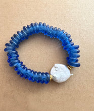 Load image into Gallery viewer, For the blues lover out there,  this stack features a blue recycled glass bracelet with a coin pearl accents stone, and blue polymer clay bracelet and a lapis lazuli bracelet   All bracelets measure 7 inches but can be customized upon request 
