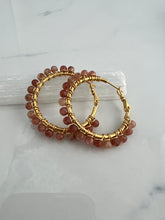 Load image into Gallery viewer, 1.5 inch 24kt gold filled hoops are hand wrapped with gorgeous faceted gemstones.  These handcrafted earrings provide just the right amount of sparkle to make any outfit shine The earrings include AAA quality gemstones, they are natural, undyed, superbly faceted and vibrant
