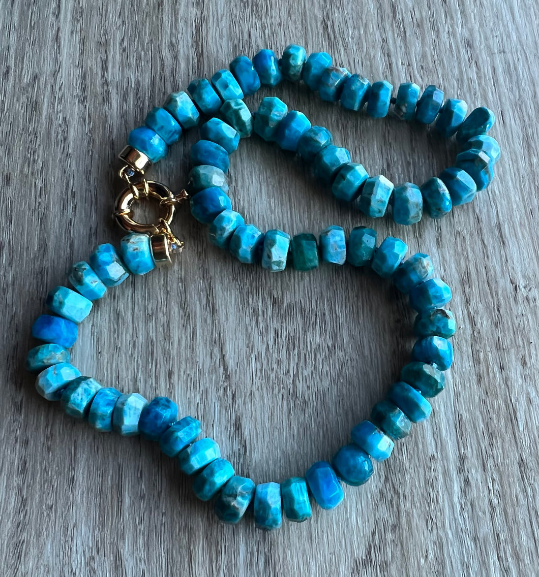 Handknotted on blue silk, this 19 inch beauty features gorgeous 9mm faceted Apatite gemstones.  Finished off with gold filled end caps and a gold filled sailor's clasp, this stunner is a one of a kind