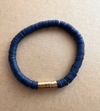 Load image into Gallery viewer, For the blues lover out there,  this stack features a blue recycled glass bracelet with a coin pearl accents stone, and blue polymer clay bracelet and a lapis lazuli bracelet   All bracelets measure 7 inches but can be customized upon request 
