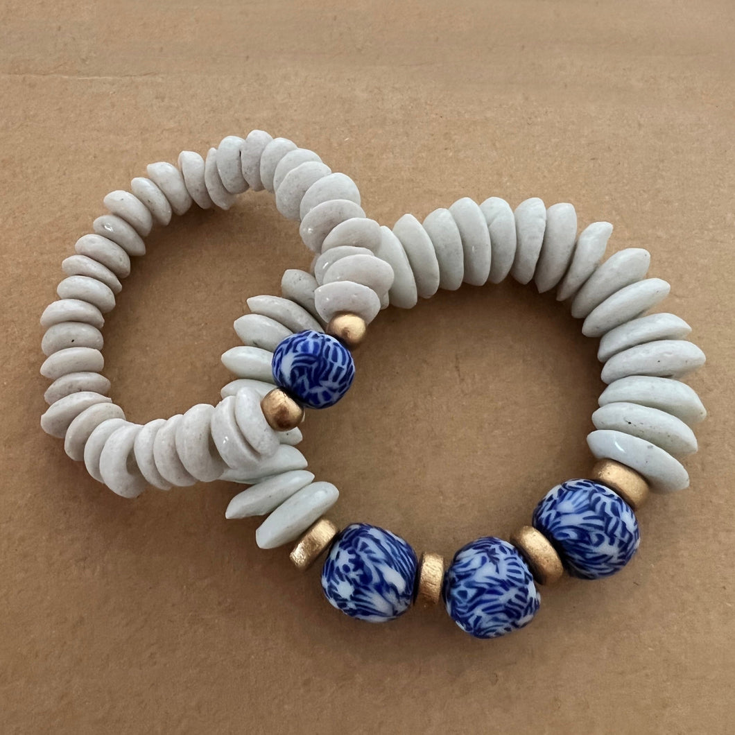 Matching bracelets with blue and white recycled glass and white ashanti beads with gold wood accents  Mommy bracelet measures seven inches but can be customized upon request.  Mini bracelet will be customized. Please mention child’s age in the notes (default will be six inches)