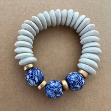 Load image into Gallery viewer, Matching bracelets with blue and white recycled glass and white ashanti beads with gold wood accents  Mommy bracelet measures seven inches but can be customized upon request.  Mini bracelet will be customized. Please mention child’s age in the notes (default will be six inches)
