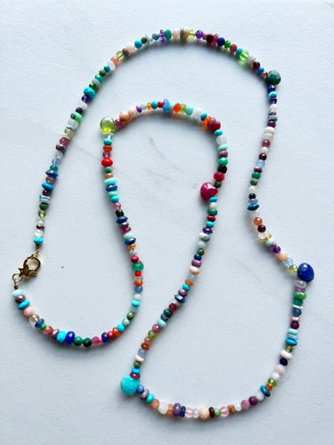 A multitude of miscellaneous gemstones for a necklace that is perfect for a white t shirt, bathing suit, sundress, blouse...you name it. Measures 30 inches and has a gold filled clasp to finish it off.   No two necklaces will ever be the same. If you have certain gemstones or colors you love please include in the notes. Length can be customized upon request 