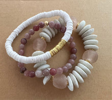 Load image into Gallery viewer, For that neutral lover that likes a hint of pink, this stack features a white ashanti glass bracelet with with pink recycled glass beads, and white polymer clay bracelet and a strawberry quartz bracelet   All bracelets measure 7 inches but can be customized upon request 
